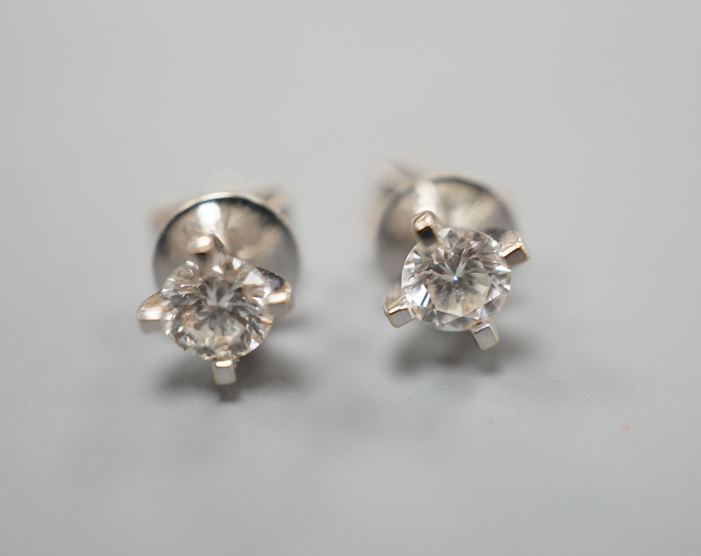 A pair of 750 white metal and solitaire diamond set ear studs, the stones measuring 3.5mm in diameter, gross weight 1.1 grams.